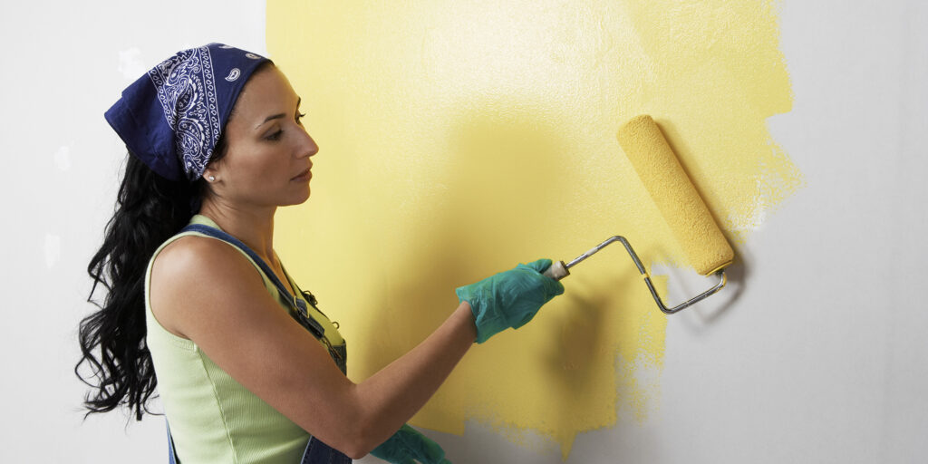 Woman Painting Room with Roller