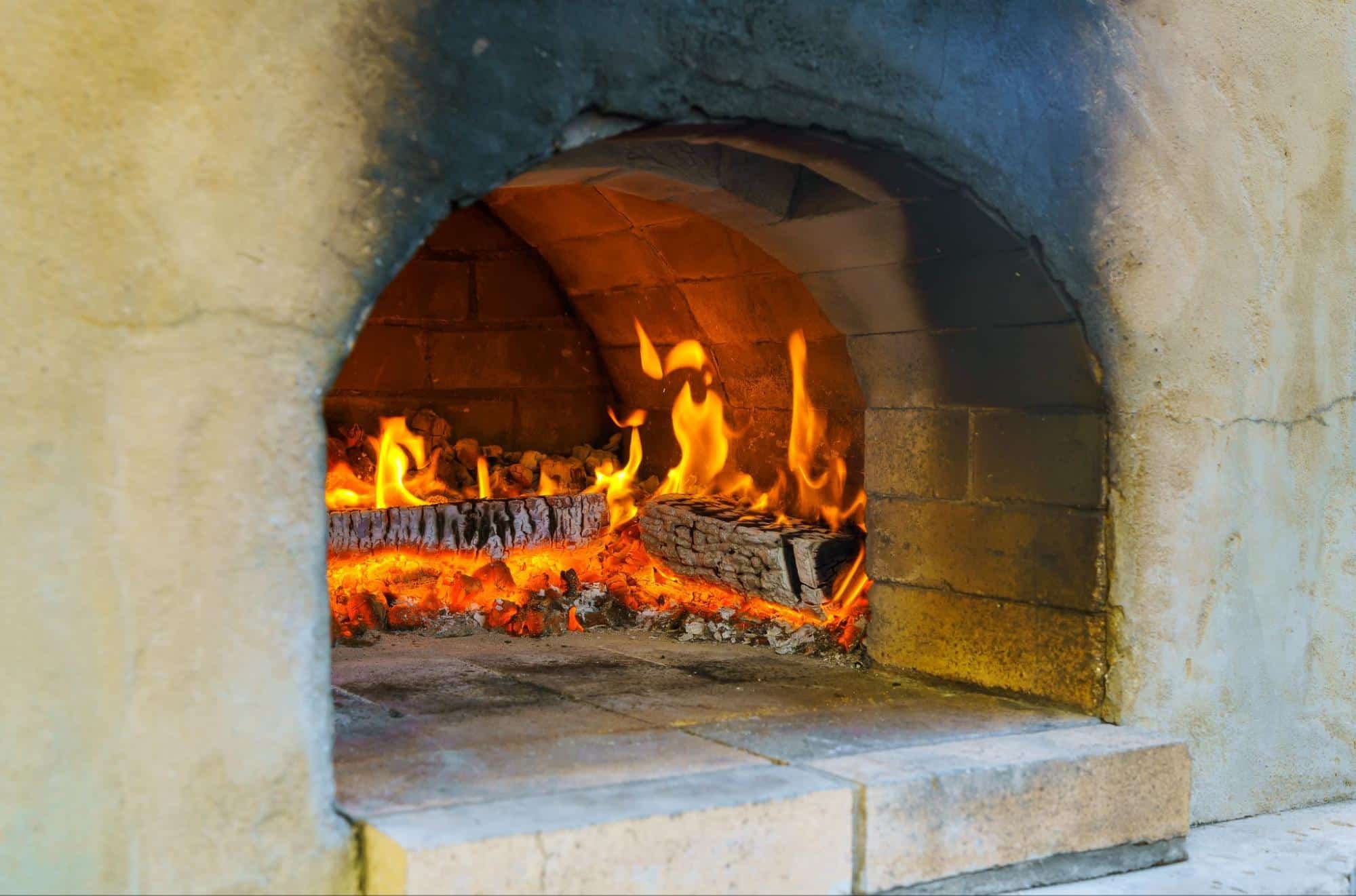 logs burning in a traditional pizza oven